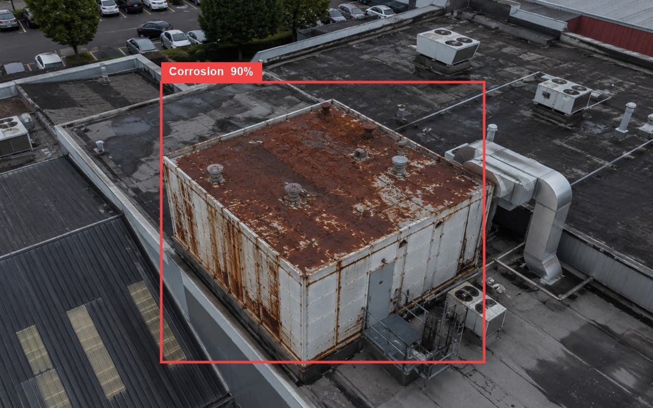 Real AI defect detection: corrosion flagged on a commercial rooftop with a bounding box